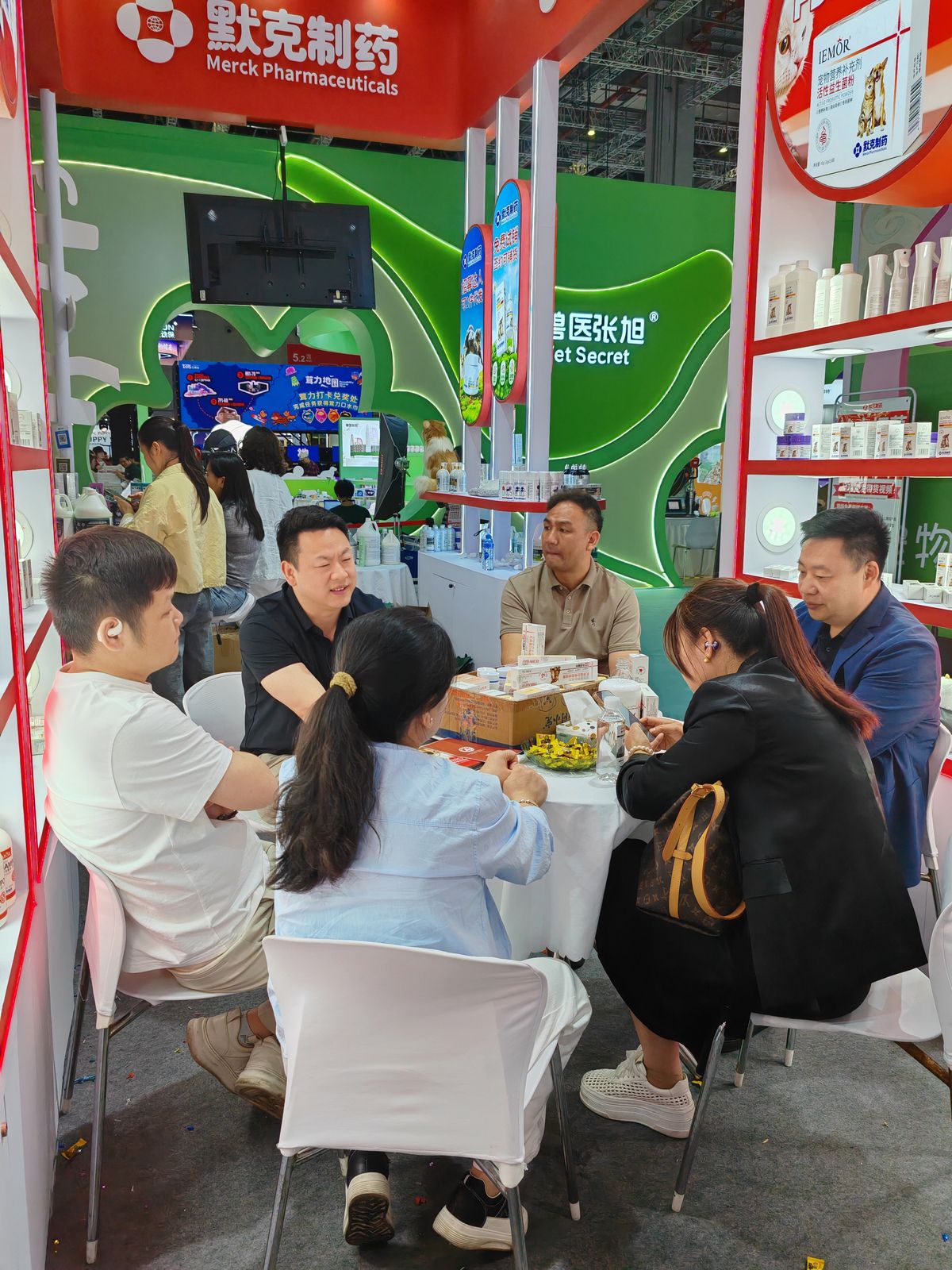 Business consultations at the Merck Pharmaceuticals booth